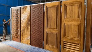 Indonesian teak door manufacturer inspecting custom solid wood doors for export (1)
